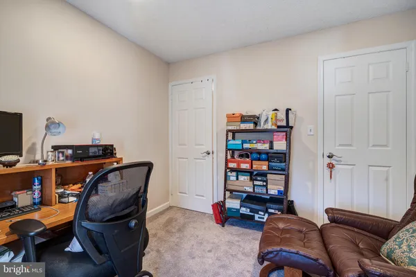 a living room with furniture a couch and book shelf