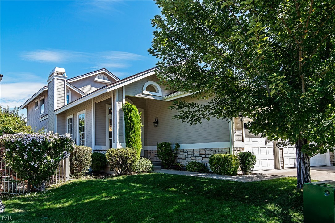 6182 Squires Lane Reno, NV 89519 - Photo 1 of 17 a front view of a house with a yard