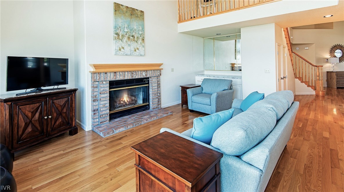 6182 Squires Lane Reno, NV 89519 - Photo 13 of 17 a living room with furniture a flat screen tv and a fireplace