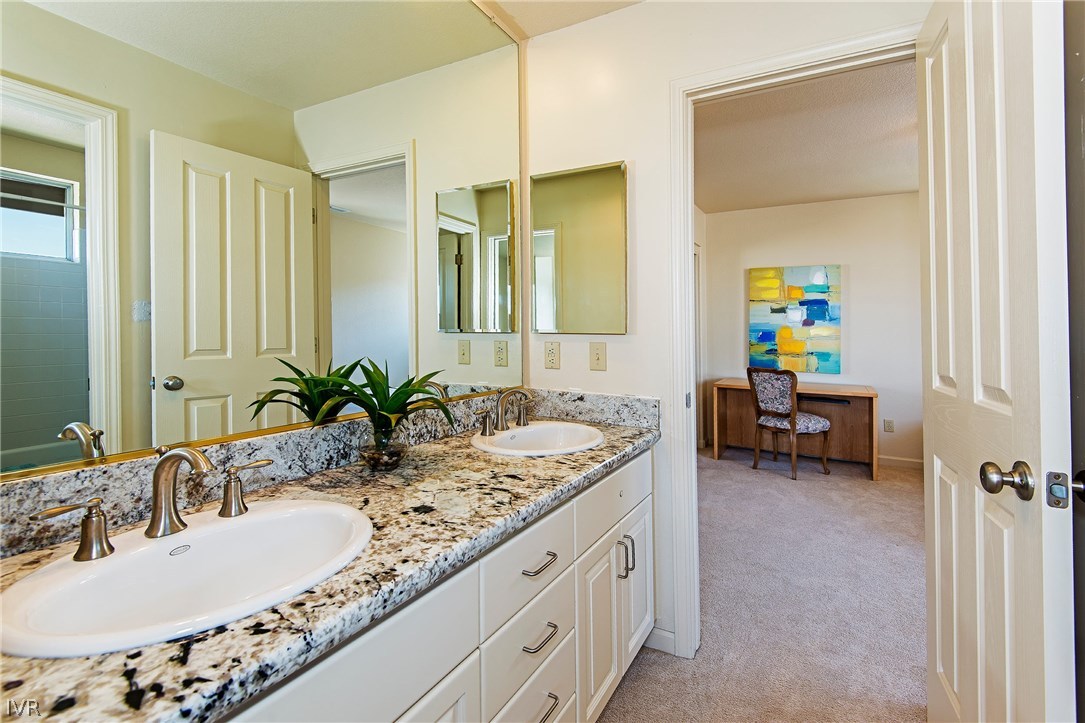 6182 Squires Lane Reno, NV 89519 - Photo 14 of 17 a bathroom with a granite countertop sink and a mirror
