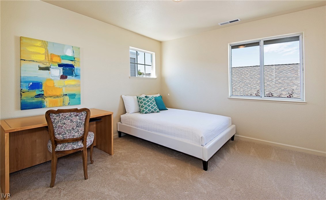 6182 Squires Lane Reno, NV 89519 - Photo 15 of 17 a bedroom with a bed and a chair