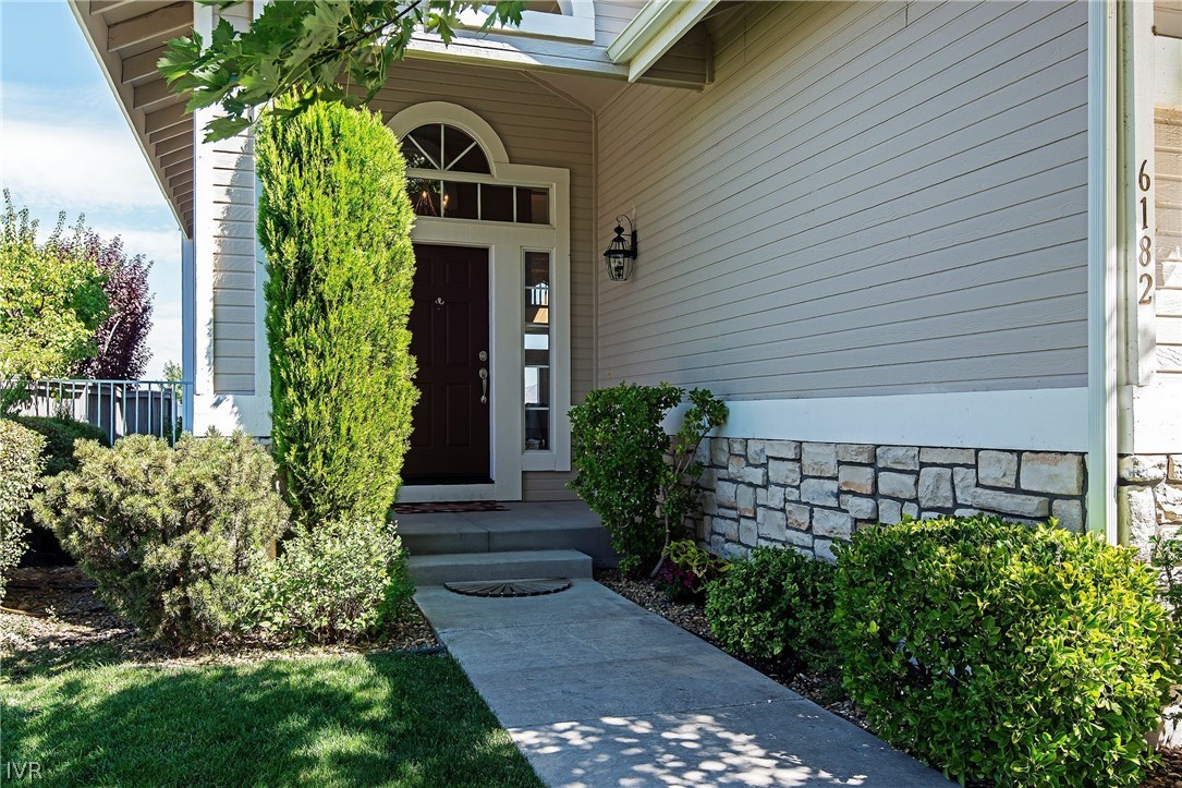 6182 Squires Lane Reno, NV 89519 - Photo 16 of 17 a front view of a house with garden