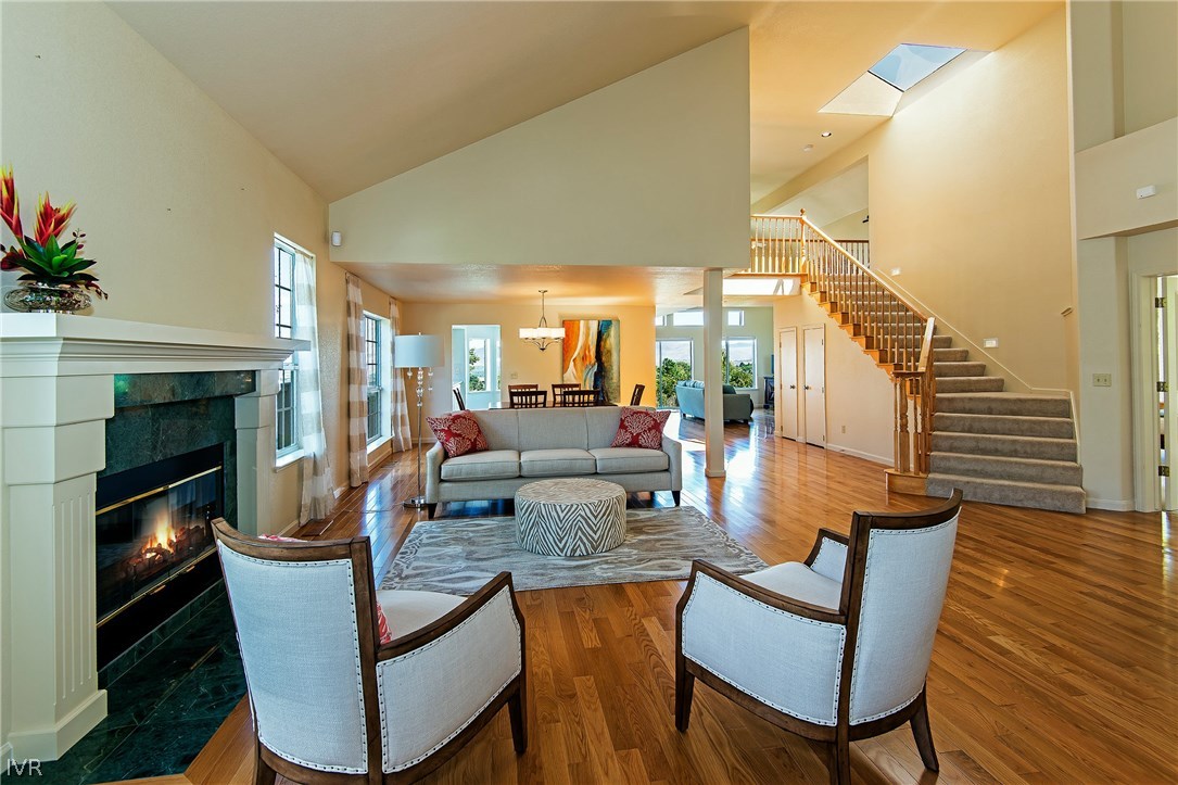 6182 Squires Lane Reno, NV 89519 - Photo 2 of 17 a dining room with furniture a fireplace and wooden floor