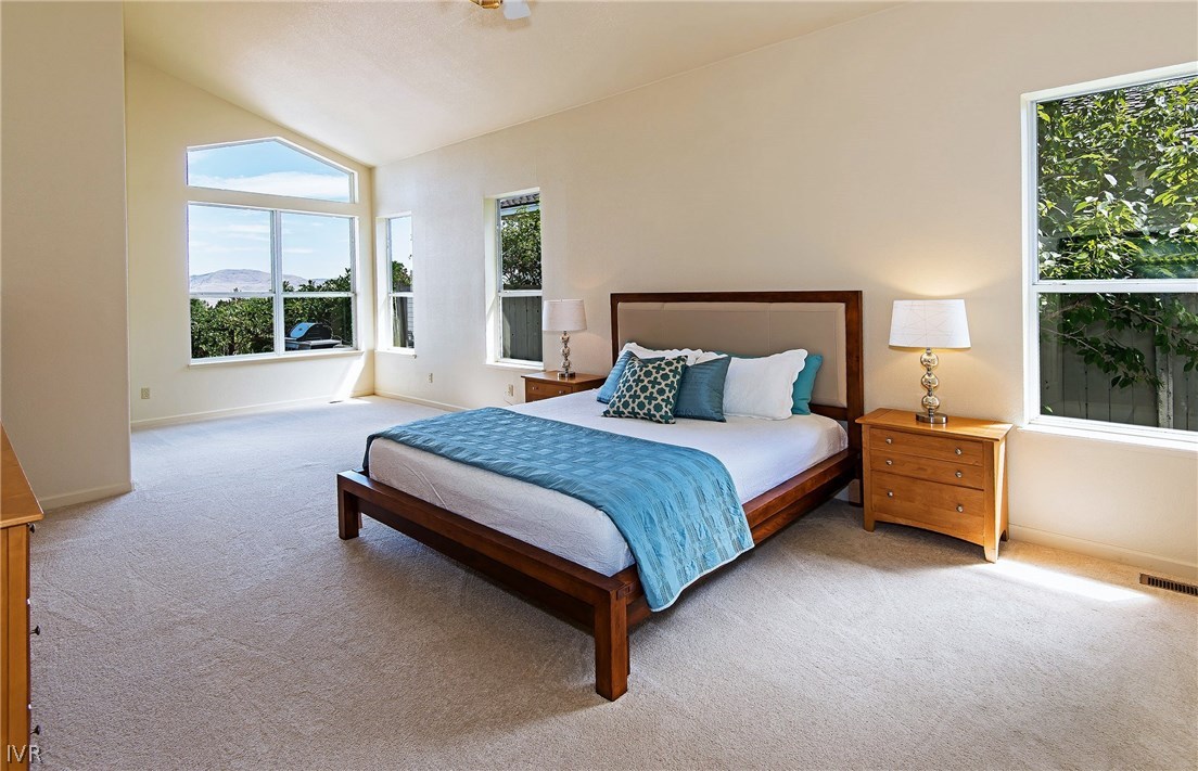 6182 Squires Lane Reno, NV 89519 - Photo 10 of 17 a spacious bedroom with a bed and a large window