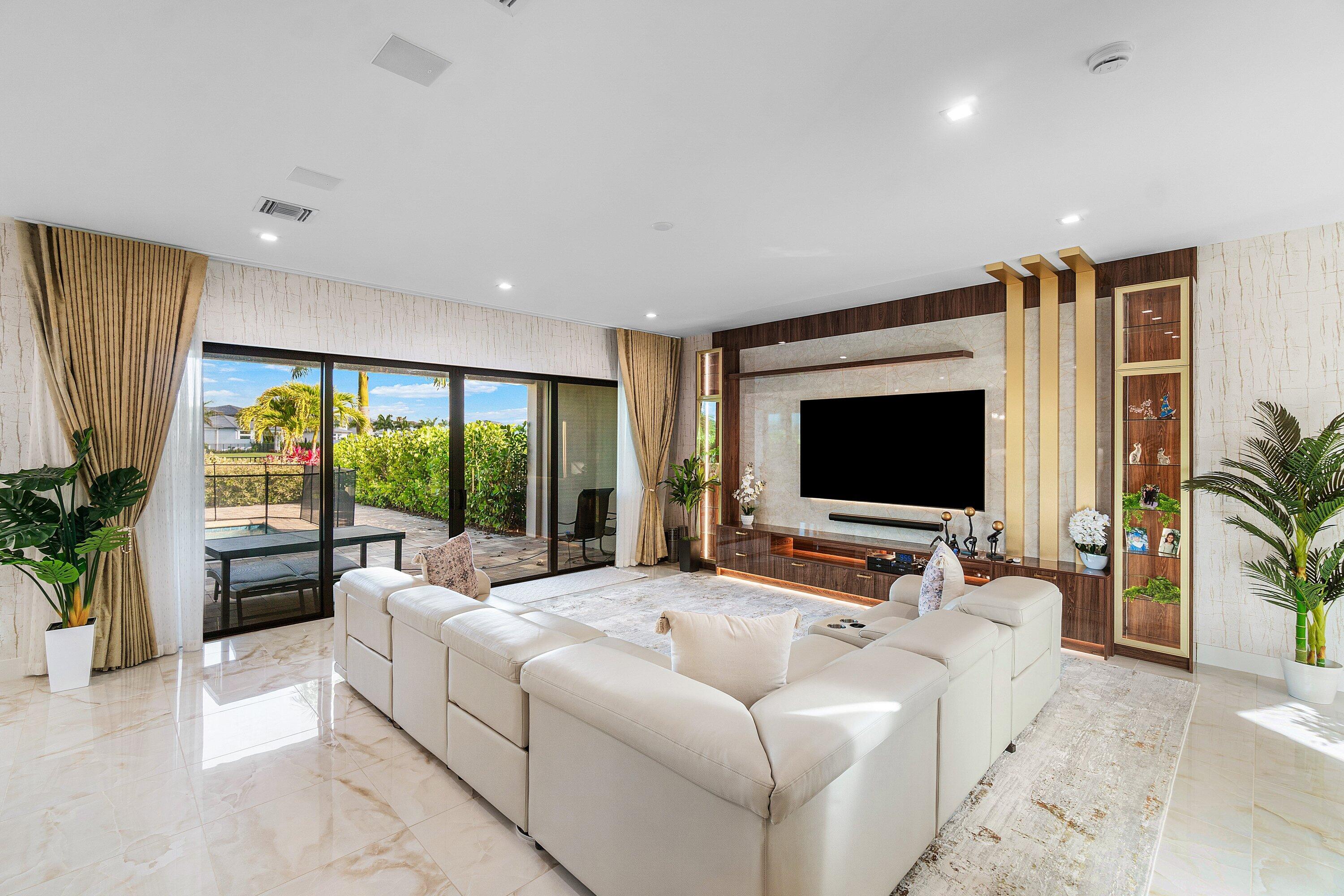 8233 Crystal Downs Avenue Boca Raton, FL 33434 - Photo 10 of 58 a living room with furniture and a flat screen tv