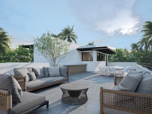 a view of house with couch and outdoor seating