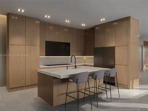 a kitchen with stainless steel appliances kitchen island hardwood floor and chairs