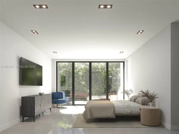 a living room with couch a flat screen tv and a floor to ceiling window