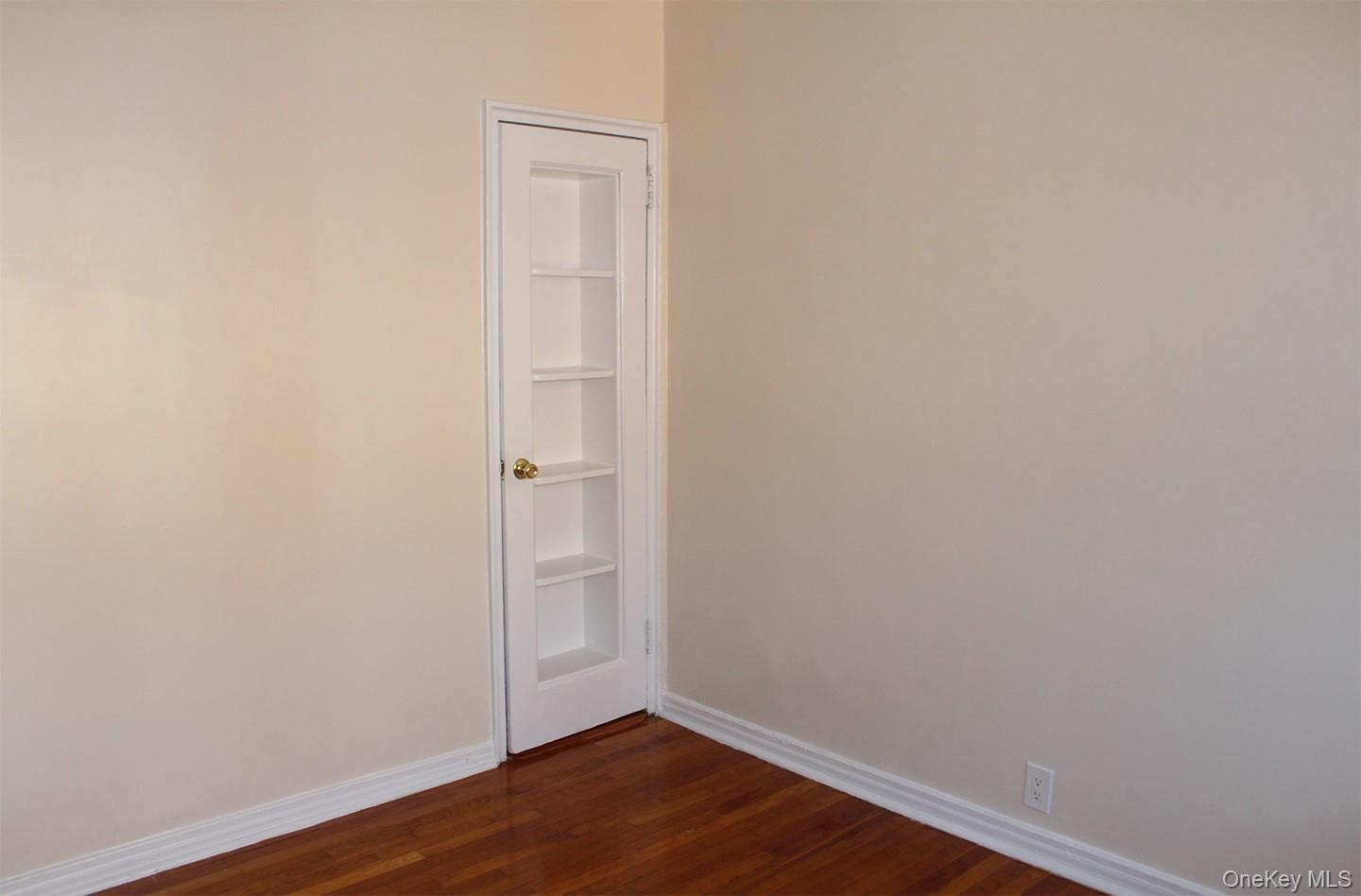 811 Bronx River Road, Unit 5A Yonkers, NY 10708 - Photo 11 of 18 Empty room featuring baseboards and dark wood-style flooring
