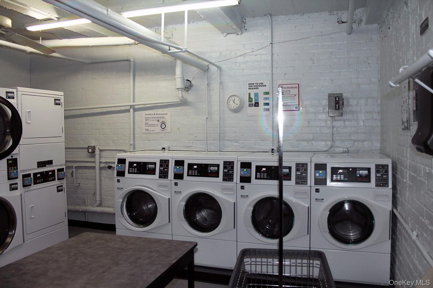 811 Bronx River Road, Unit 5A Yonkers, NY 10708 - Photo 18 of 18 Shared laundry with brick wall and separate washer and dryer