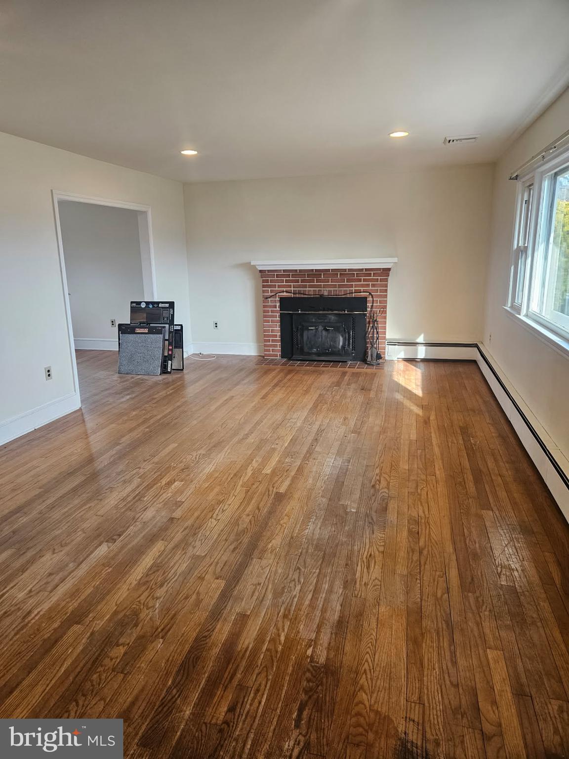 21 Manor Drive Dover, DE 19901 - Photo 11 of 24 a view of empty room with wooden floor and fireplace