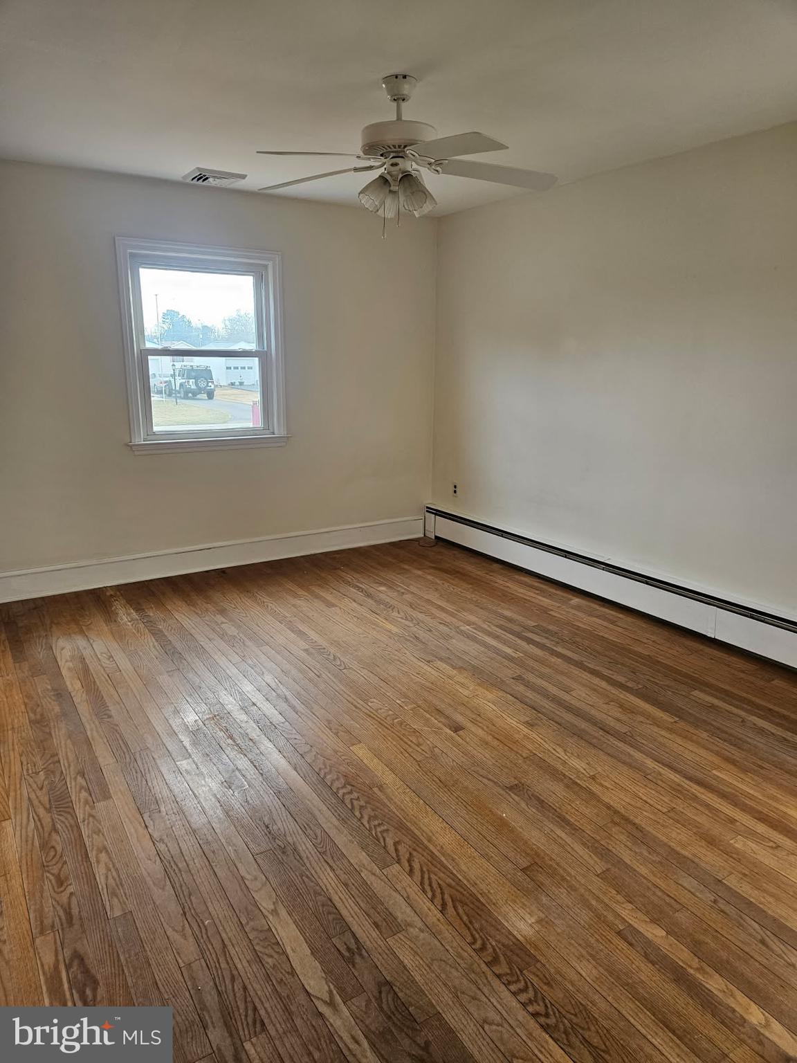 21 Manor Drive Dover, DE 19901 - Photo 18 of 24 an empty room with wooden floor chandelier fan and windows