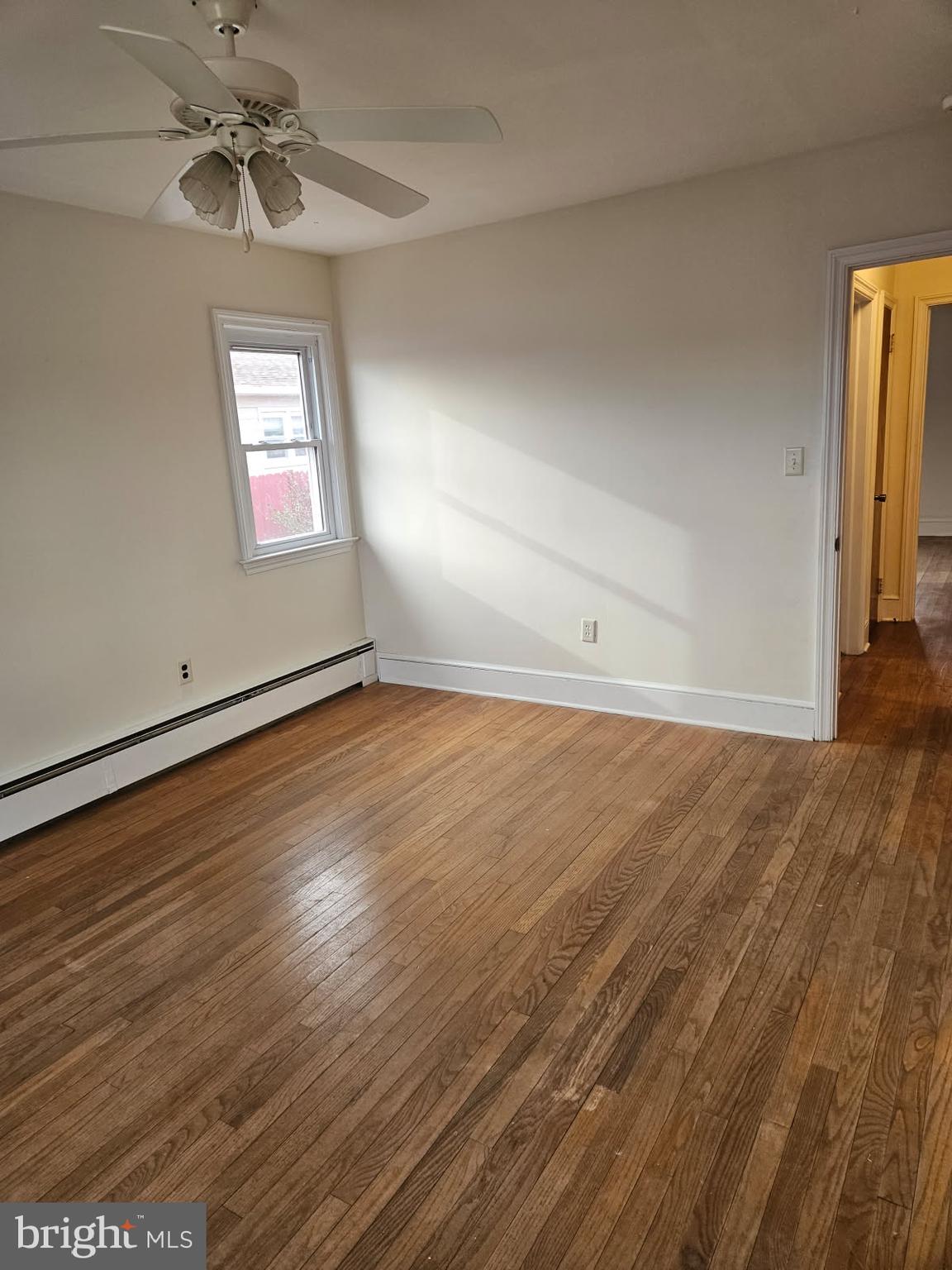 21 Manor Drive Dover, DE 19901 - Photo 19 of 24 an empty room with wooden floor chandelier fan and windows