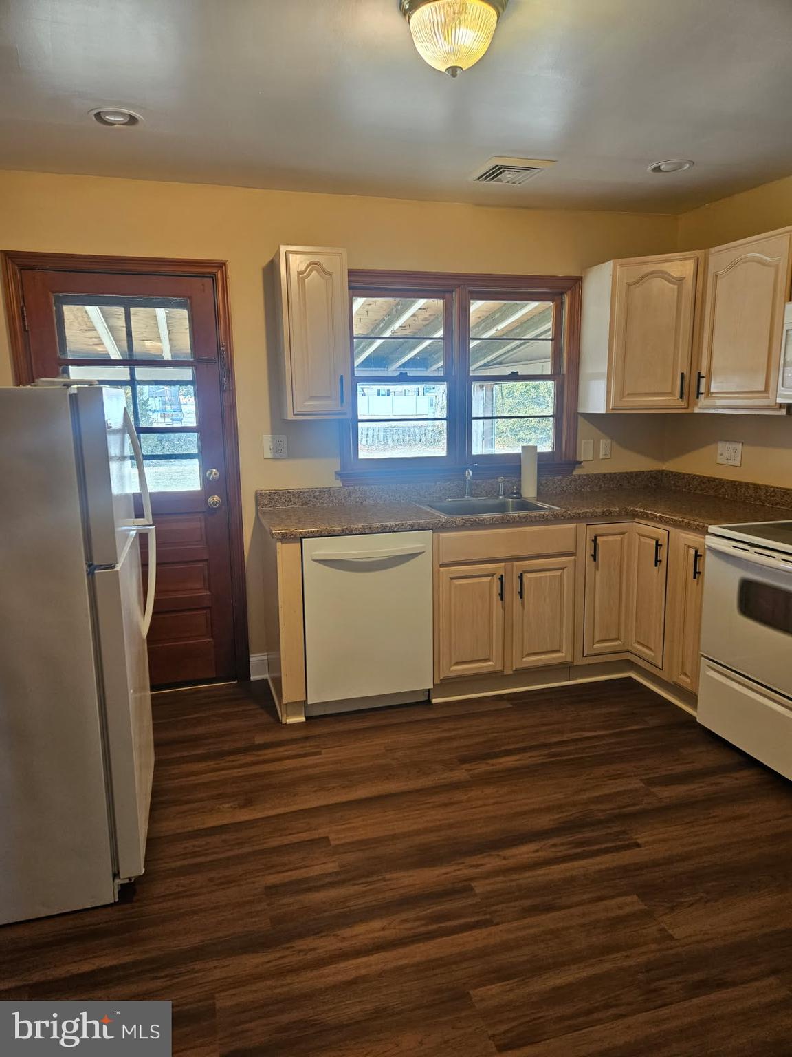 21 Manor Drive Dover, DE 19901 - Photo 8 of 24 a kitchen with stainless steel appliances granite countertop a stove a sink and a refrigerator