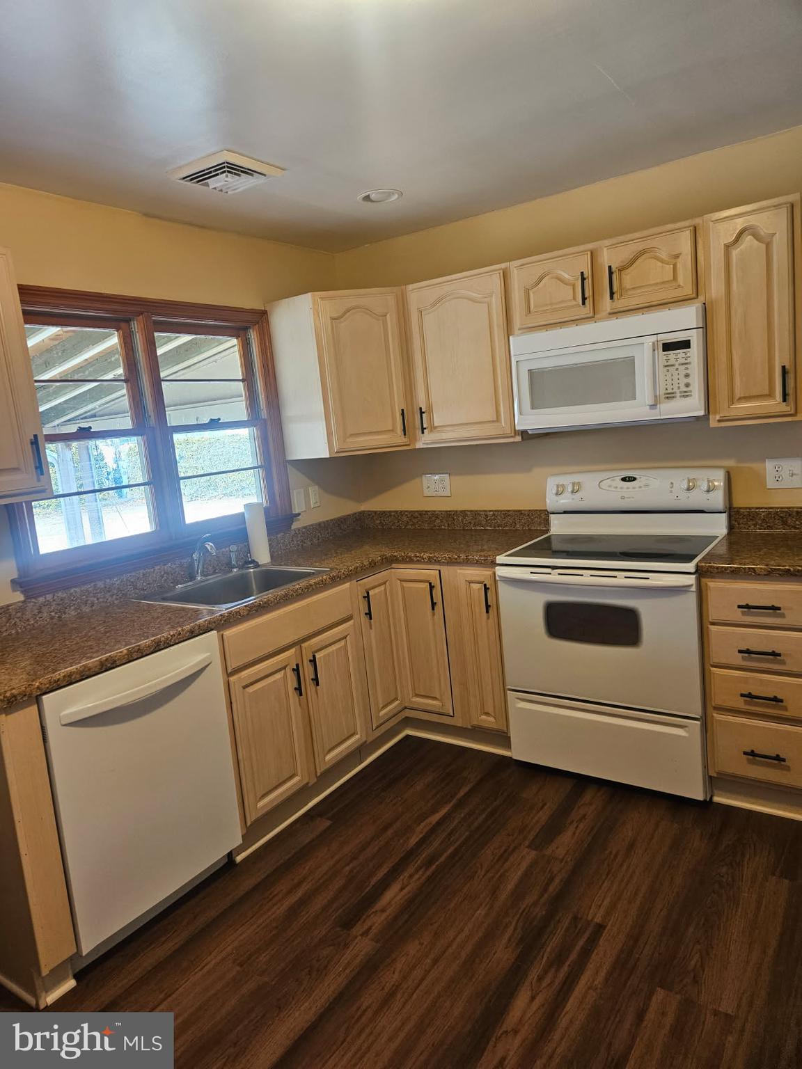 21 Manor Drive Dover, DE 19901 - Photo 9 of 24 a kitchen with granite countertop white cabinets and white appliances