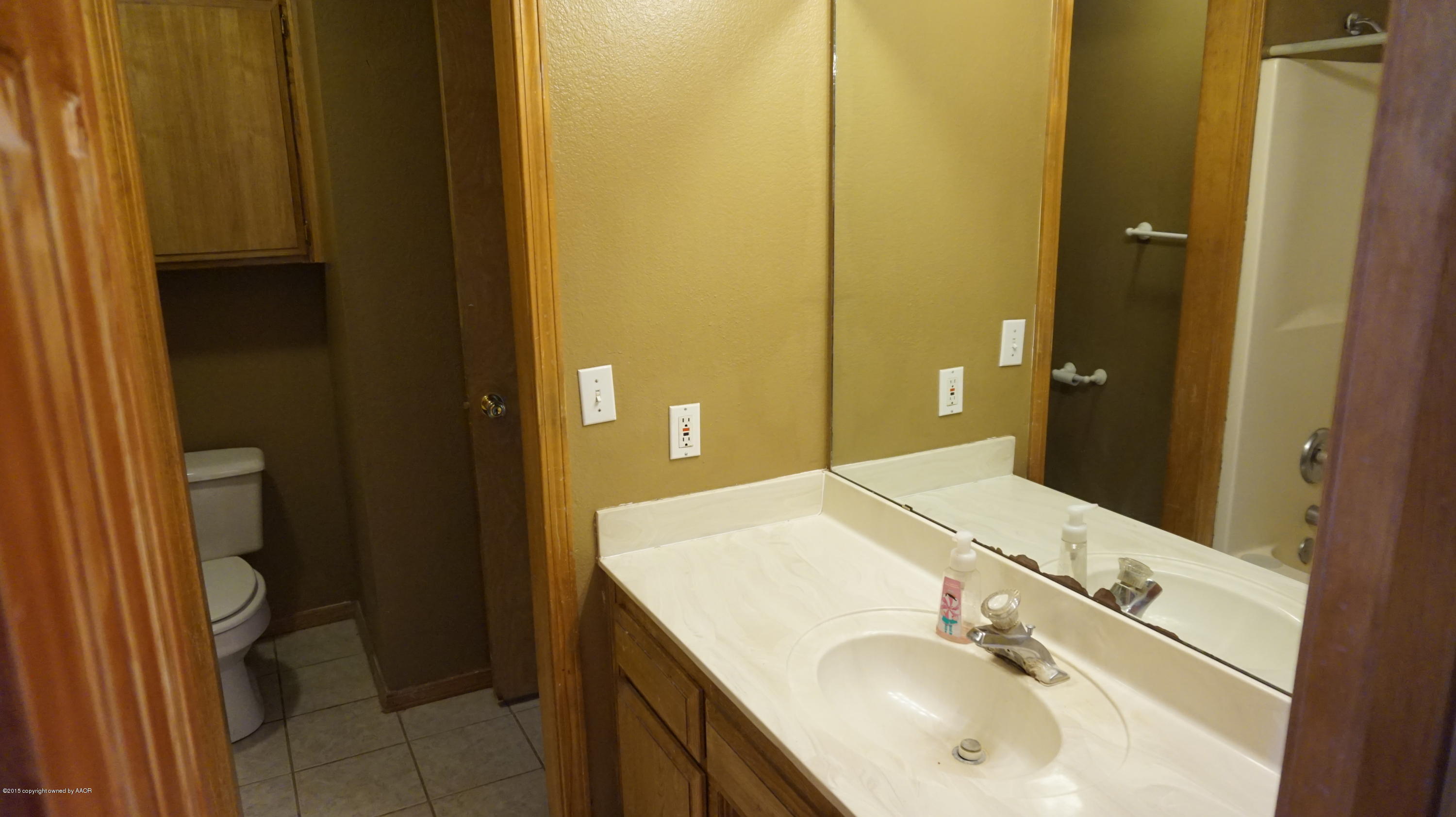 5228 Capulin Lane Amarillo, TX 79110 - Photo 11 of 16 a bathroom with a sink and a mirror