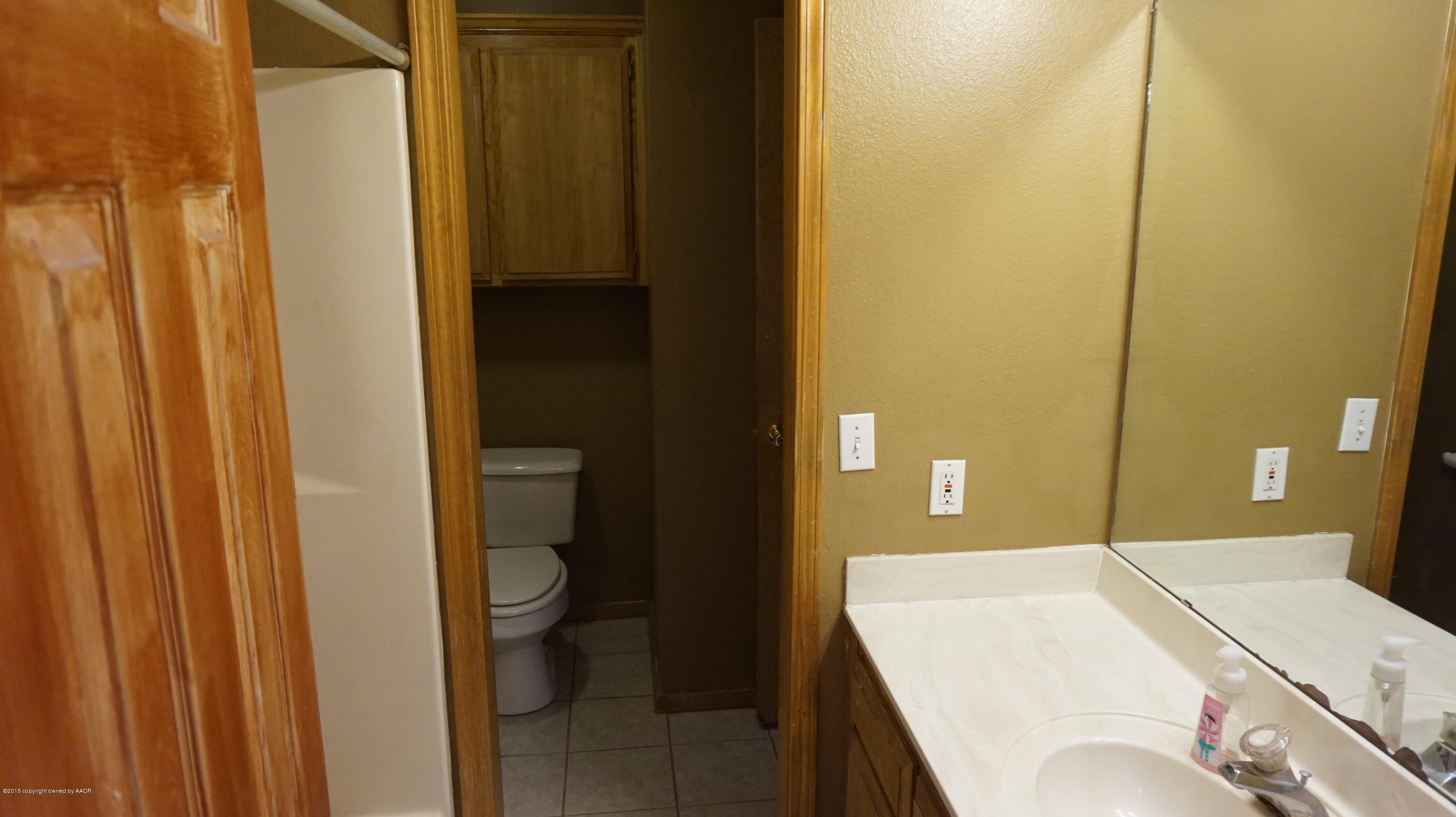 5228 Capulin Lane Amarillo, TX 79110 - Photo 12 of 16 a bathroom with a sink and toilet