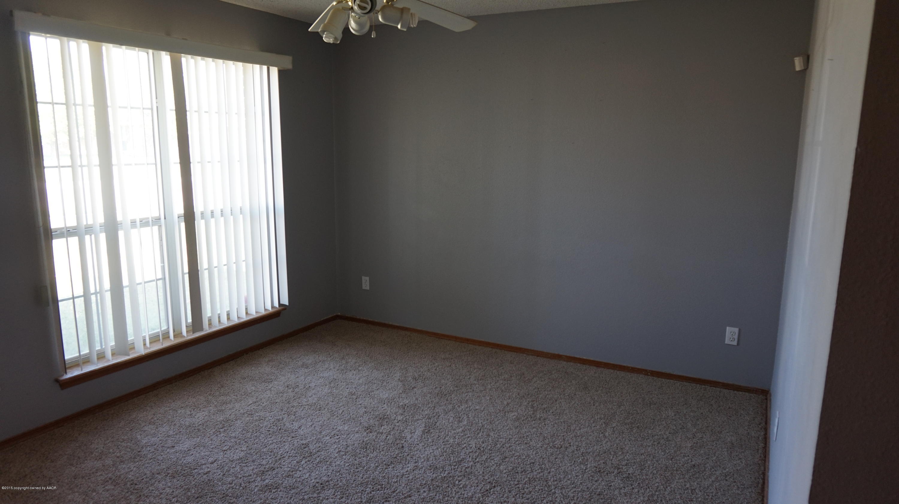5228 Capulin Lane Amarillo, TX 79110 - Photo 5 of 16 an empty room with a window