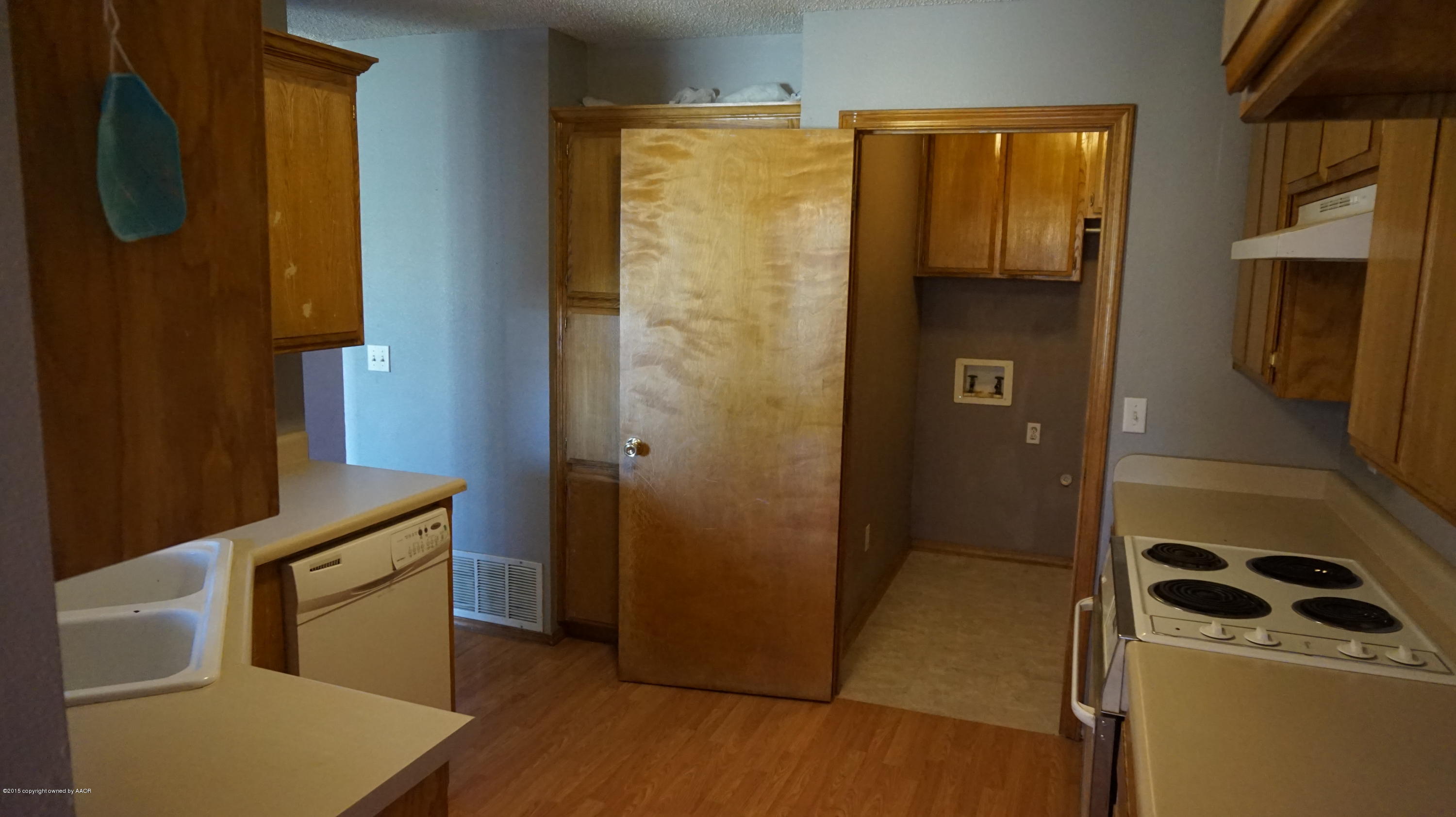 5228 Capulin Lane Amarillo, TX 79110 - Photo 7 of 16 a kitchen with a refrigerator and cabinets