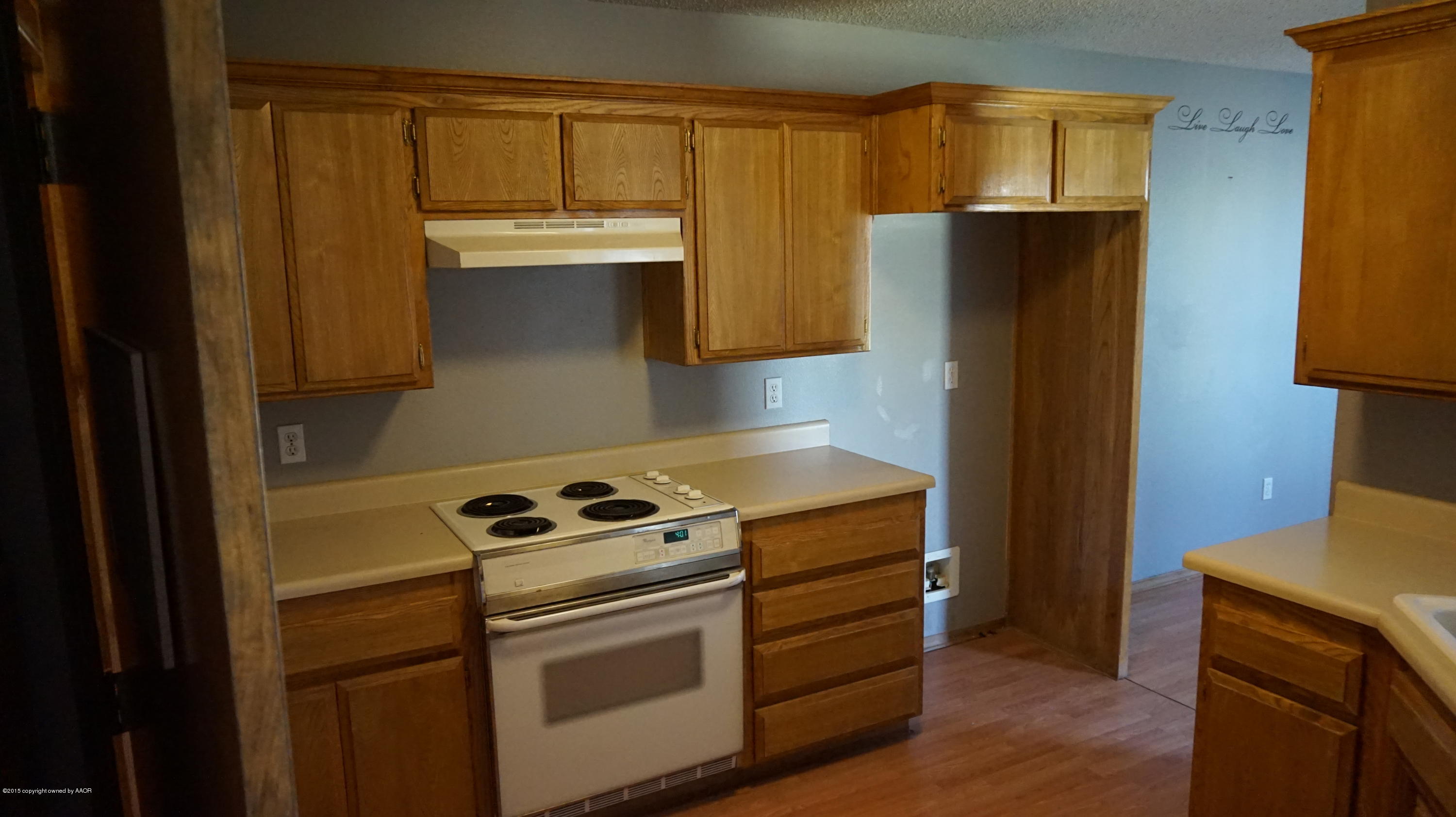5228 Capulin Lane Amarillo, TX 79110 - Photo 8 of 16 a kitchen with a stove and a refrigerator