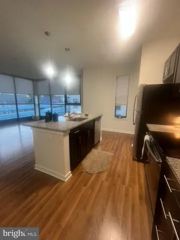 a kitchen with a sink appliances and cabinets