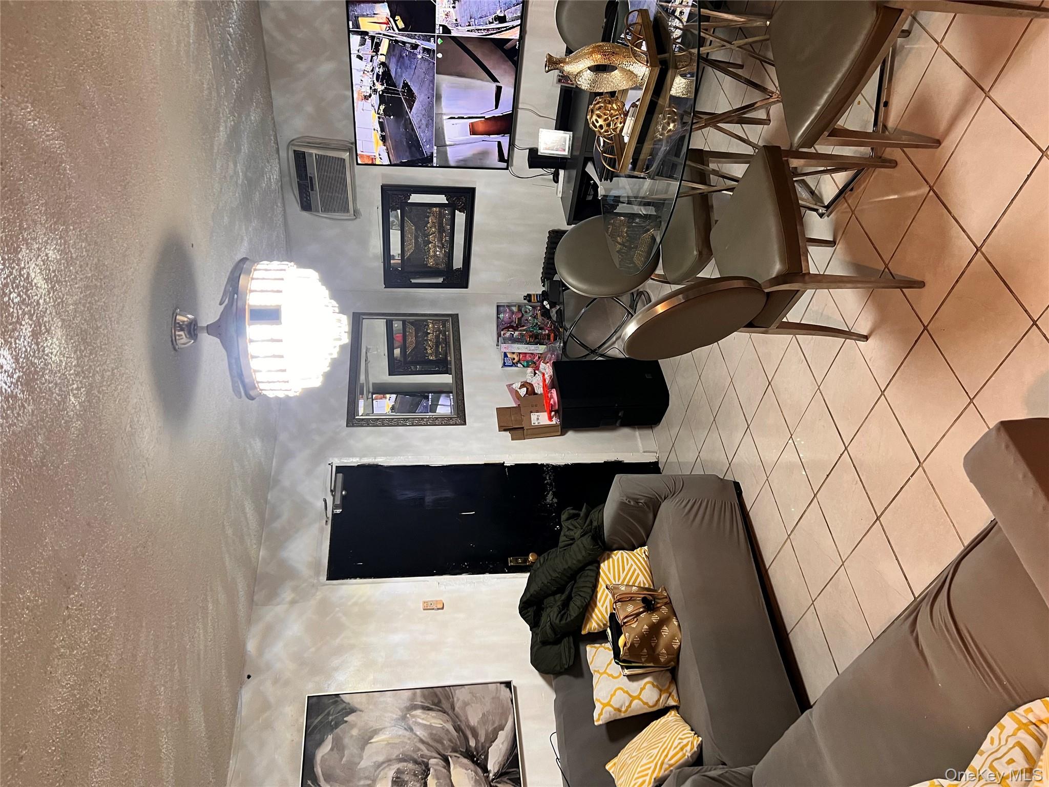 a living room with furniture kitchen view and a chandelier