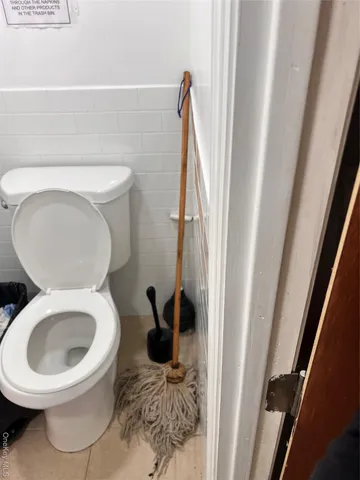 a kitchen with stainless steel appliances a sink stove and white cabinets