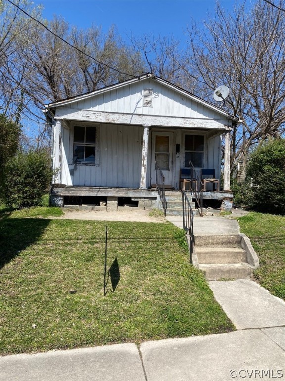 a view of a house with backyard porch and sitting area