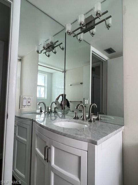 3250 10th Street North, Unit A6 Naples, FL 34103 - Photo 11 of 12 a bathroom with a granite countertop sink a mirror and vanity