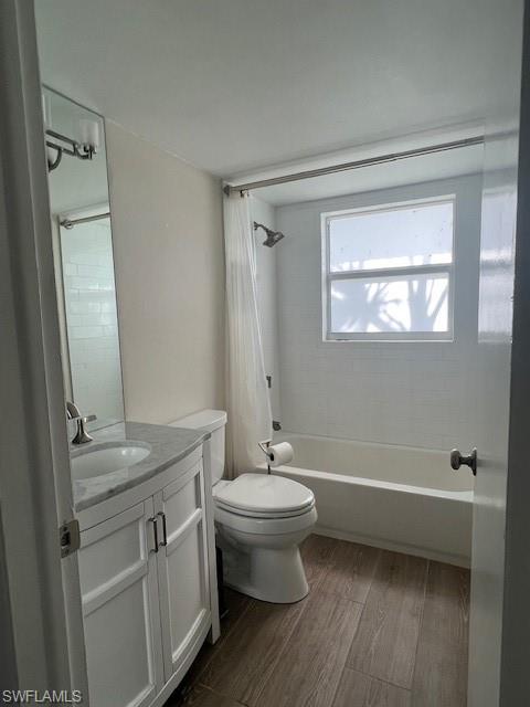 3250 10th Street North, Unit A6 Naples, FL 34103 - Photo 12 of 12 a bathroom with a granite countertop sink toilet a mirror and shower