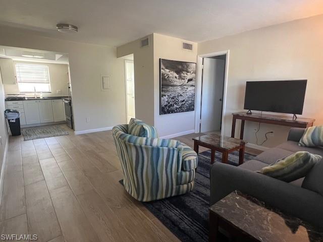 3250 10th Street North, Unit A6 Naples, FL 34103 - Photo 3 of 12 a living room with furniture and a flat screen tv