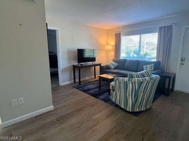 3250 10th Street North, Unit A6 Naples, FL 34103 - Photo 4 of 12 a living room with furniture and a flat screen tv