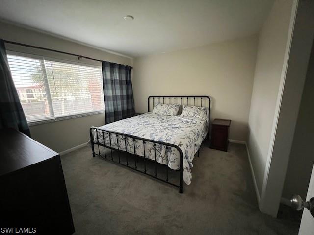 3250 10th Street North, Unit A6 Naples, FL 34103 - Photo 7 of 12 a bed sitting in a bedroom next to a window