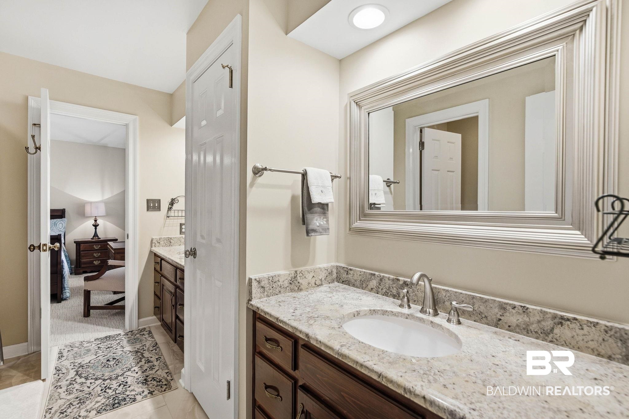 31515 Rhett Drive Spanish Fort, AL 36527 - Photo 49 of 100 The Jack and Jill bathroom has a large linen closet, private water closet, and a custom tiled shower tub combination, and a large linen closet.