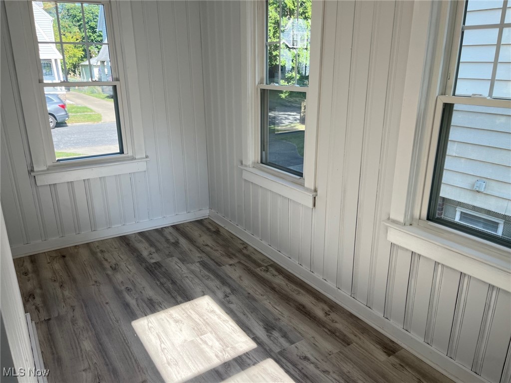1148 Sylvania Road Cleveland Heights, OH 44121 - Photo 13 of 30 Spare room featuring LVT floors and wood walls