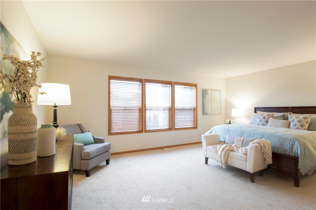 34829 Southeast Ridge Street Snoqualmie, WA 98065 - Photo 12 of 19 a spacious bedroom with a bed couch and a large window