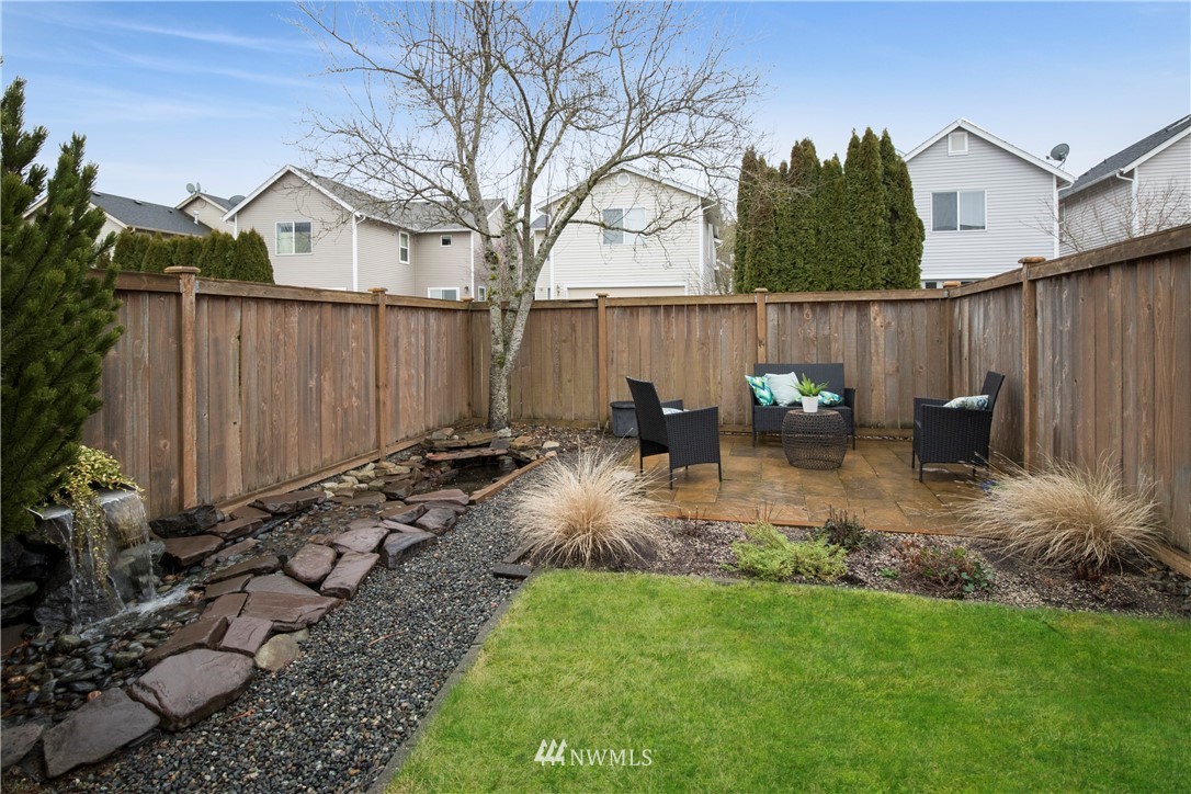34829 Southeast Ridge Street Snoqualmie, WA 98065 - Photo 17 of 19 a backyard of a house with table chairs and wooden fence