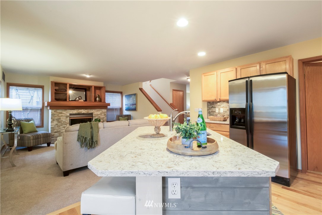 34829 Southeast Ridge Street Snoqualmie, WA 98065 - Photo 3 of 19 a kitchen with stainless steel appliances granite countertop a refrigerator a stove and a sink