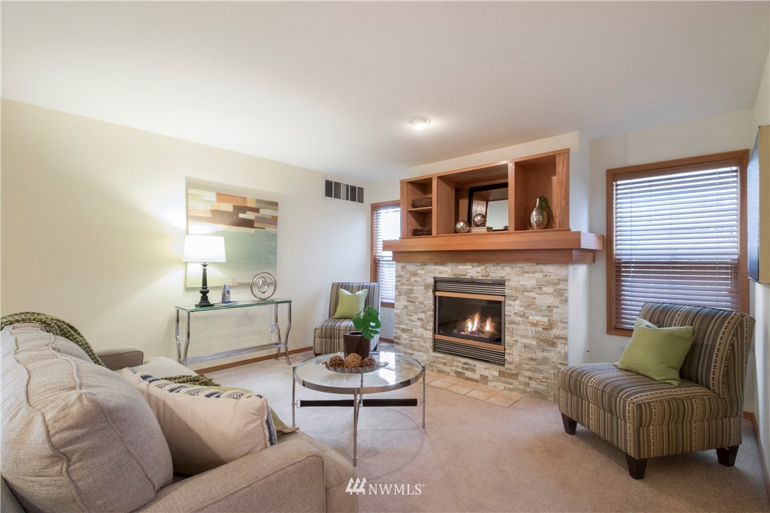 34829 Southeast Ridge Street Snoqualmie, WA 98065 - Photo 7 of 19 a living room with furniture and a fireplace