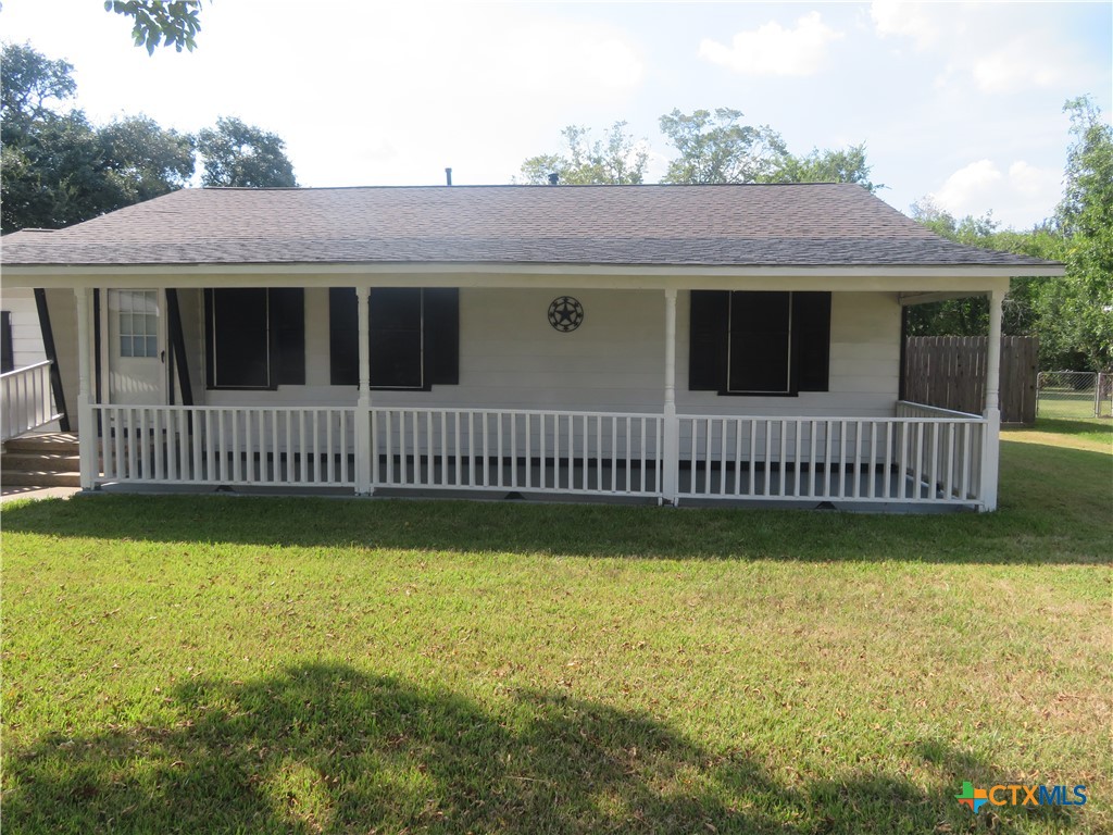a view of a house with a yard and deck