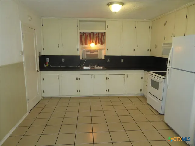 a kitchen with a sink and cabinets