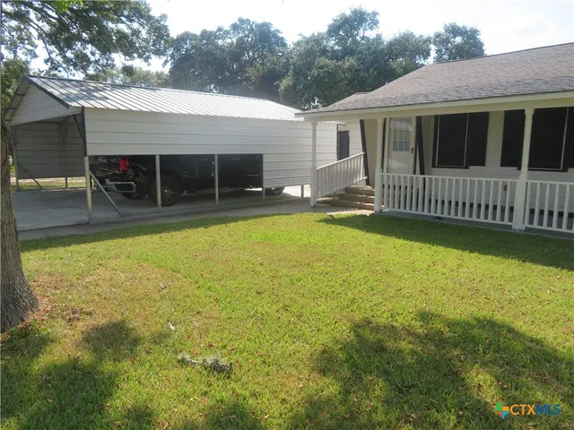 a view of a house with swimming pool and a yard