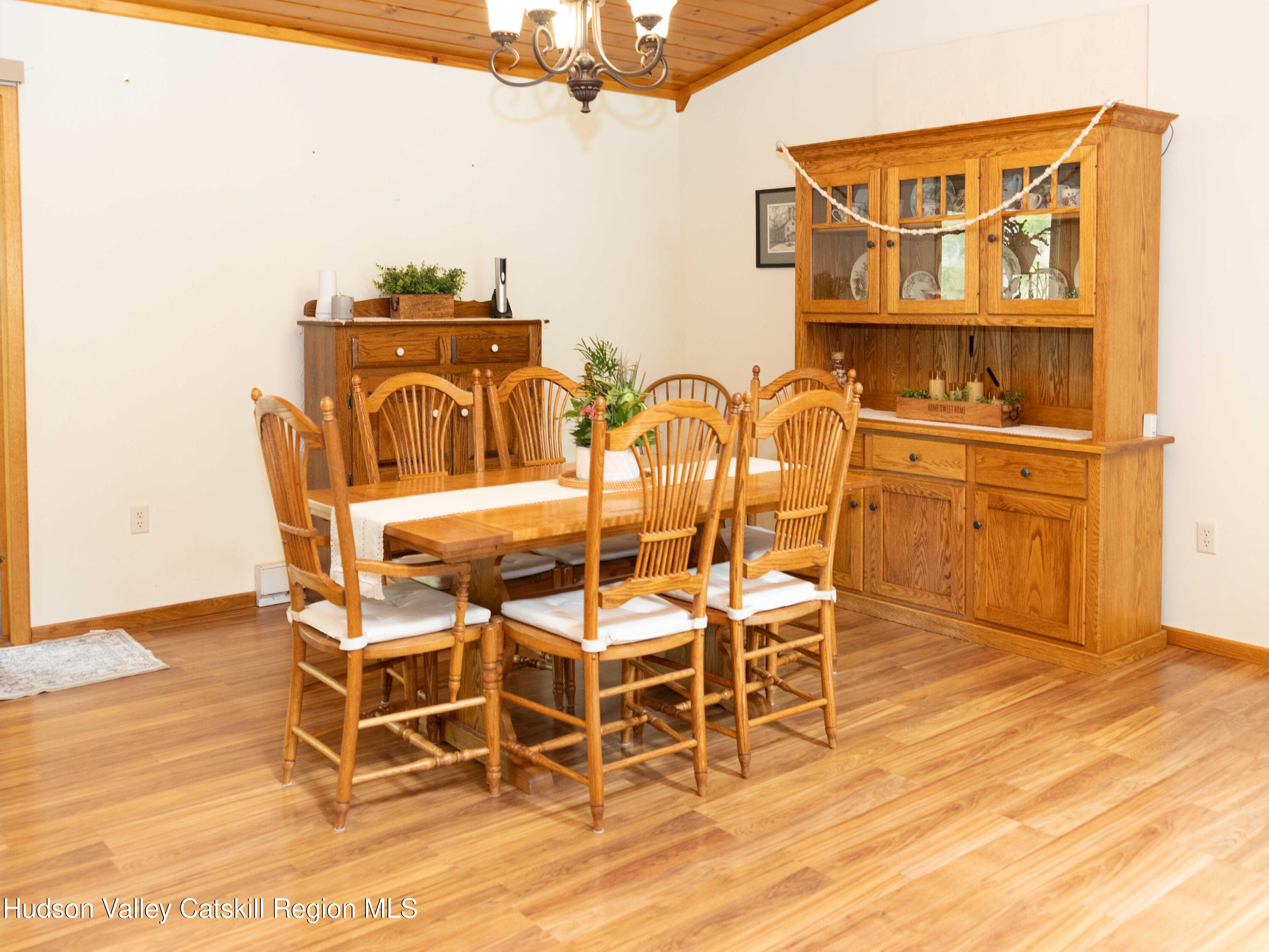 736 Plattekill Road Freehold, NY 12431 - Photo 19 of 47 a view of a dining room with furniture and wooden floor
