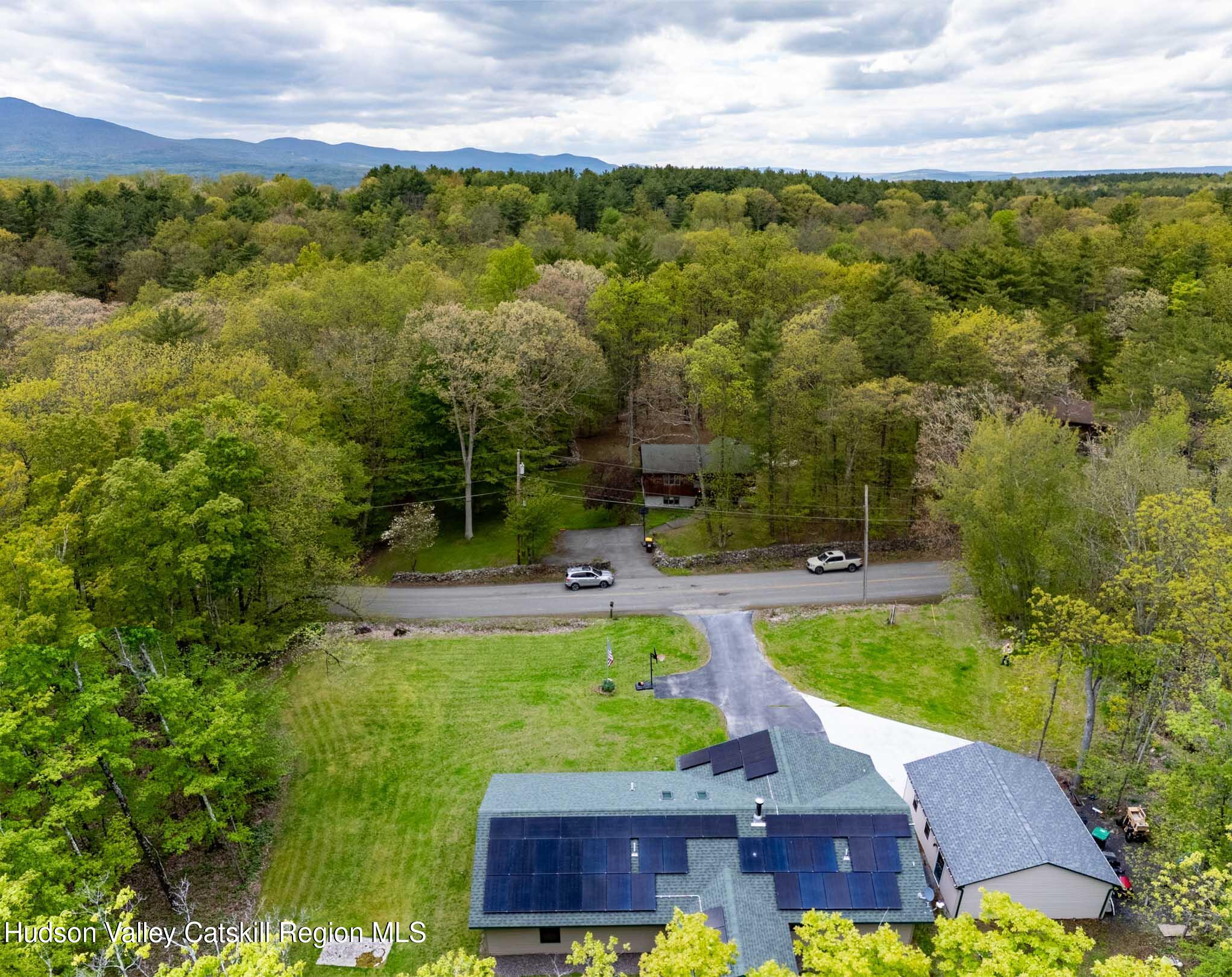 736 Plattekill Road Freehold, NY 12431 - Photo 3 of 47 a view of a swimming pool with lawn chairs and a potted plants