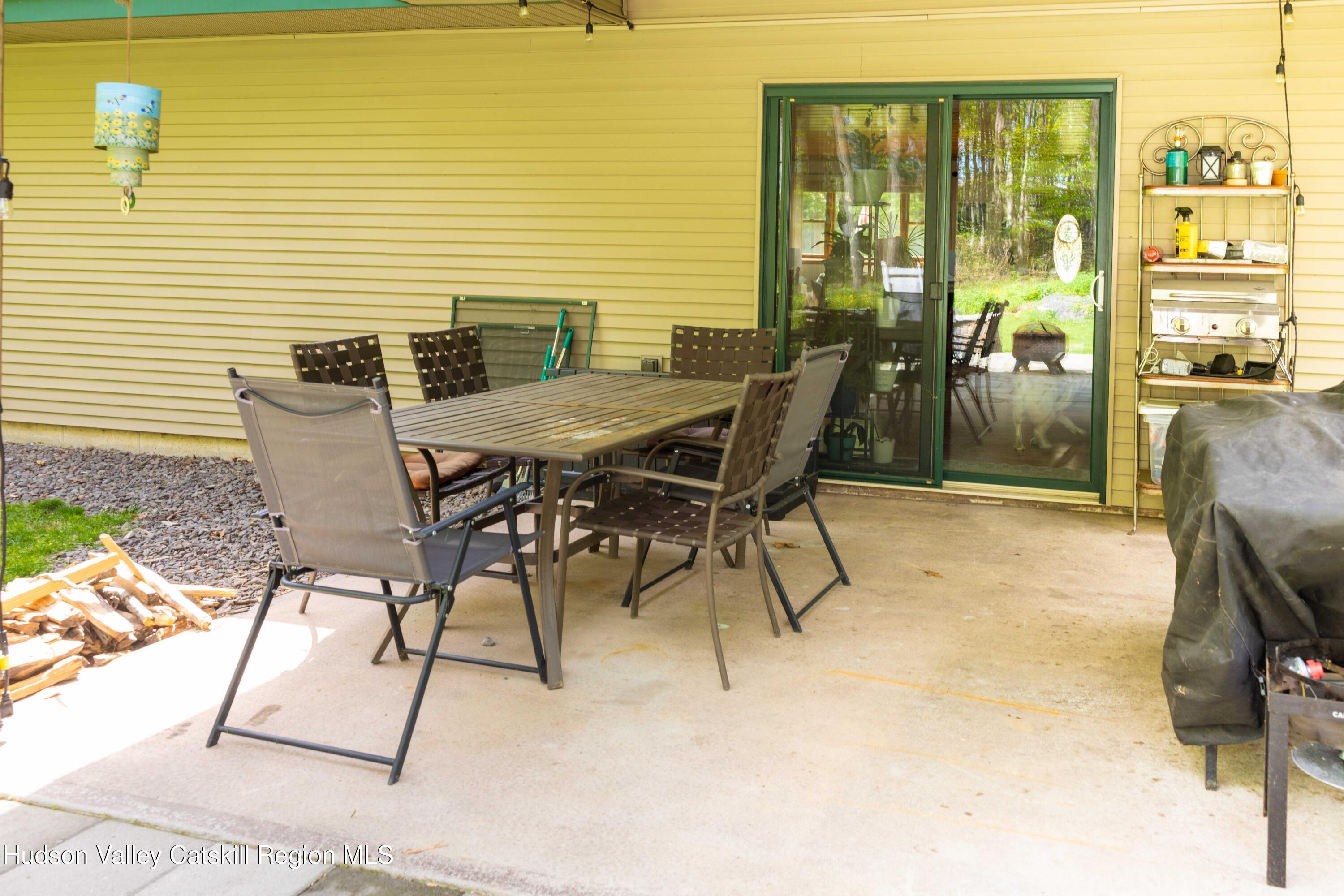 736 Plattekill Road Freehold, NY 12431 - Photo 44 of 47 a patio with table and chairs and potted plants
