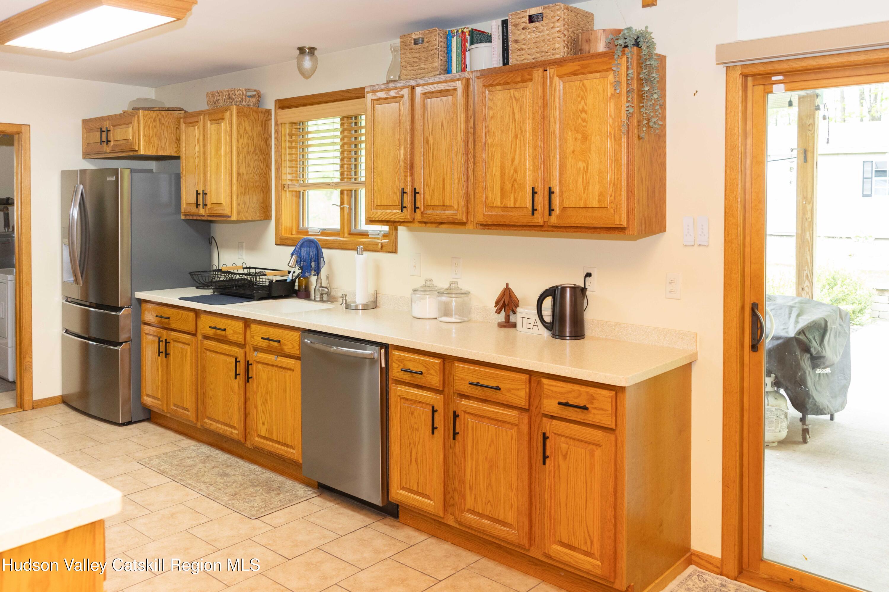 736 Plattekill Road Freehold, NY 12431 - Photo 7 of 47 a kitchen with stainless steel appliances a sink cabinets and a window