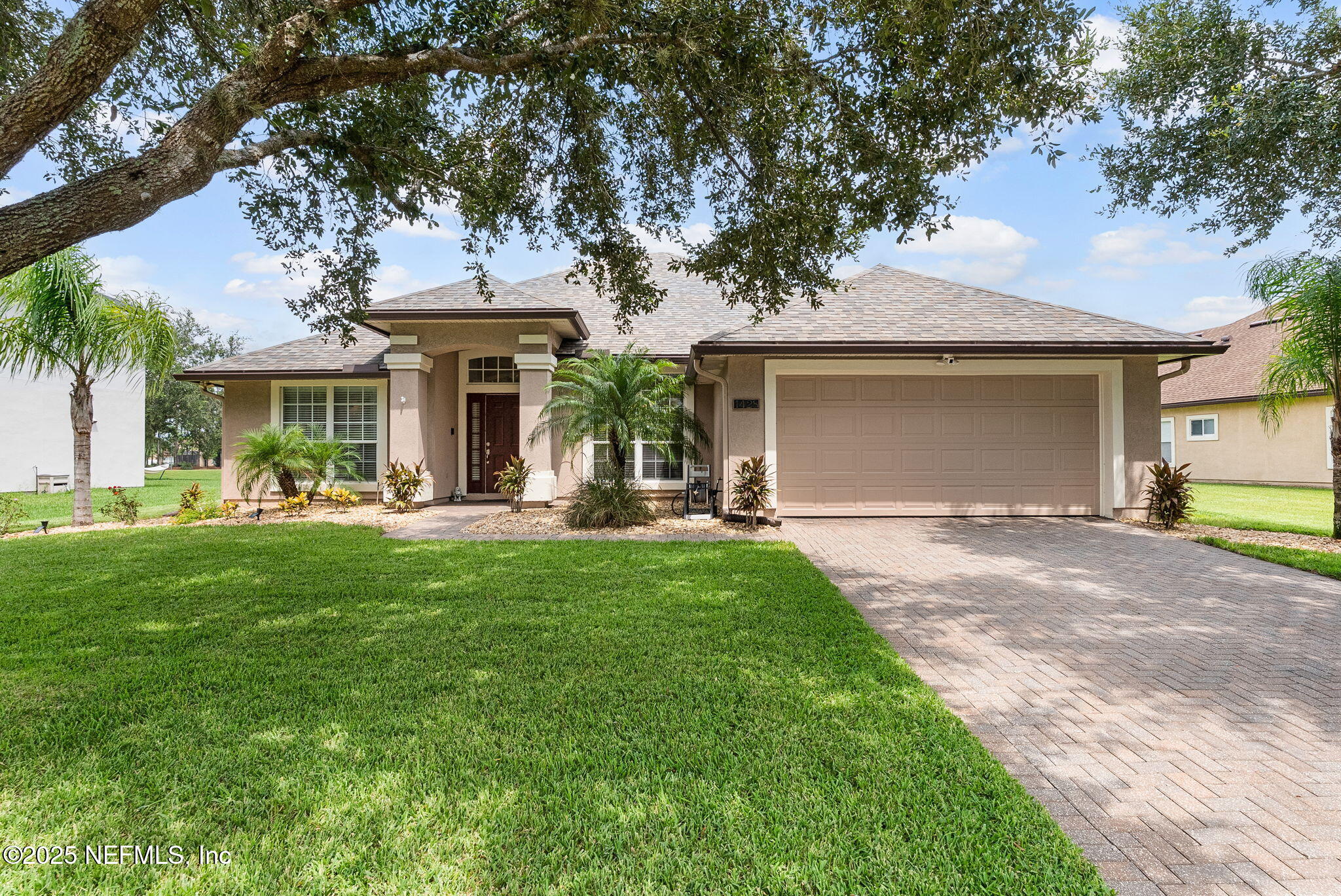 1428 Riva Del Garda Way St. Augustine, FL 32092 - Photo 1 of 44 a front view of a house with a garden and yard