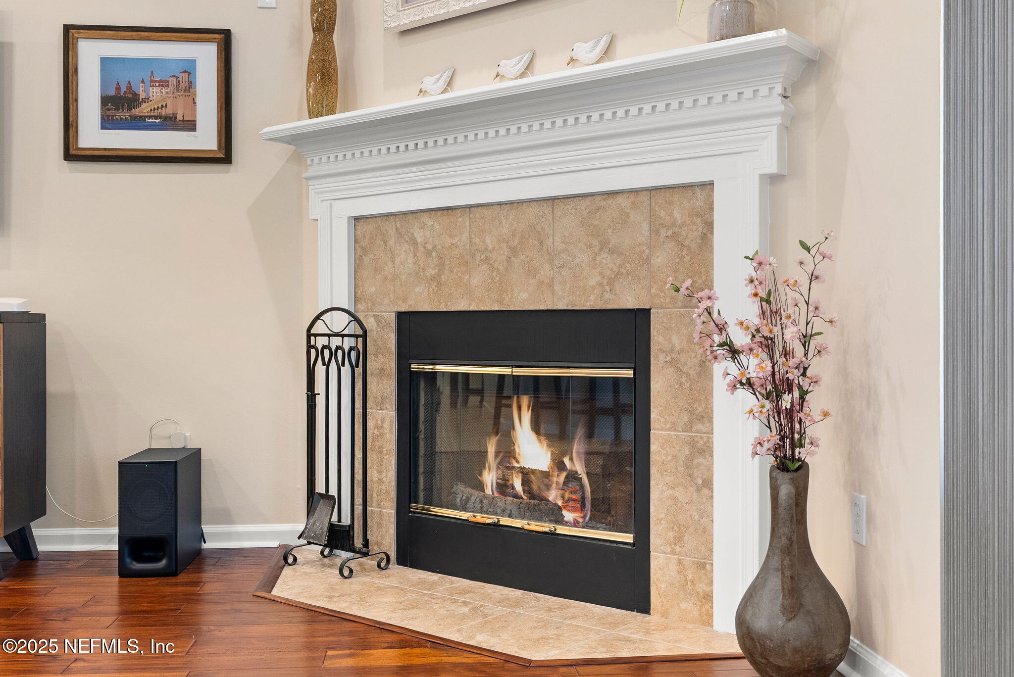 1428 Riva Del Garda Way St. Augustine, FL 32092 - Photo 18 of 44 a living room with a fireplace and a painting on the wall