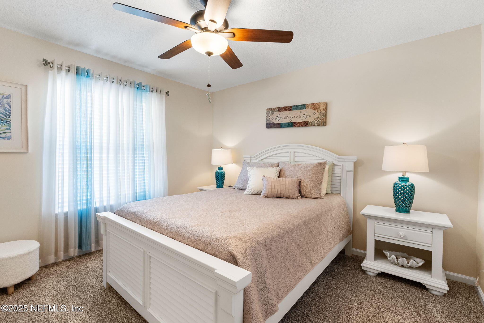 1428 Riva Del Garda Way St. Augustine, FL 32092 - Photo 27 of 44 a bedroom with a bed and a chandelier