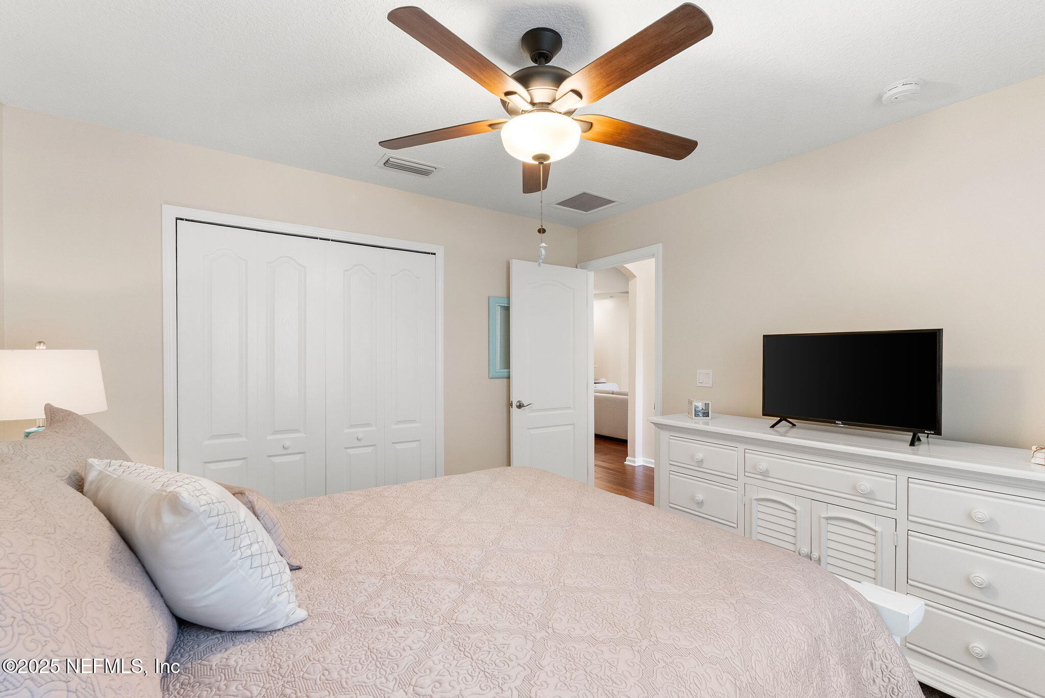 1428 Riva Del Garda Way St. Augustine, FL 32092 - Photo 28 of 44 a bedroom with a bed and a flat screen tv